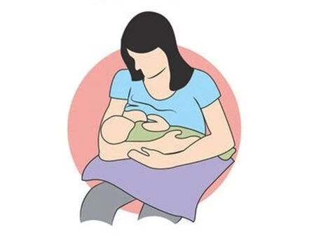 Mor sidder og ammer baby i klassisk ammestilling